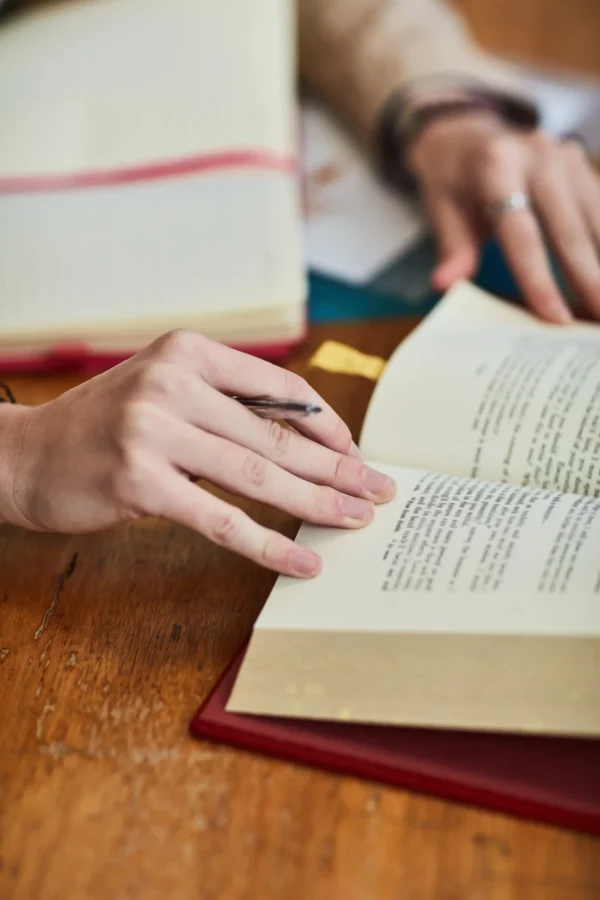 person-reading-a-book-at-a-wooden-desk-2026-01-09-09-42-15-utc